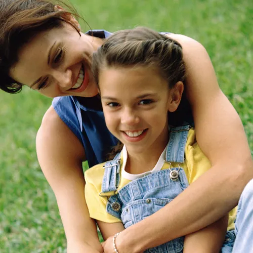 Mother and daughter sitting outside