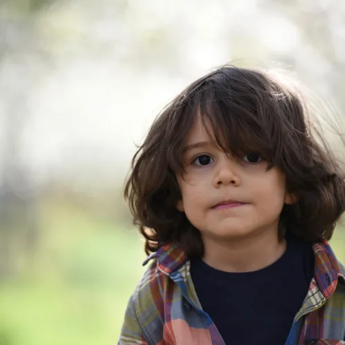 A young boy looks worried.