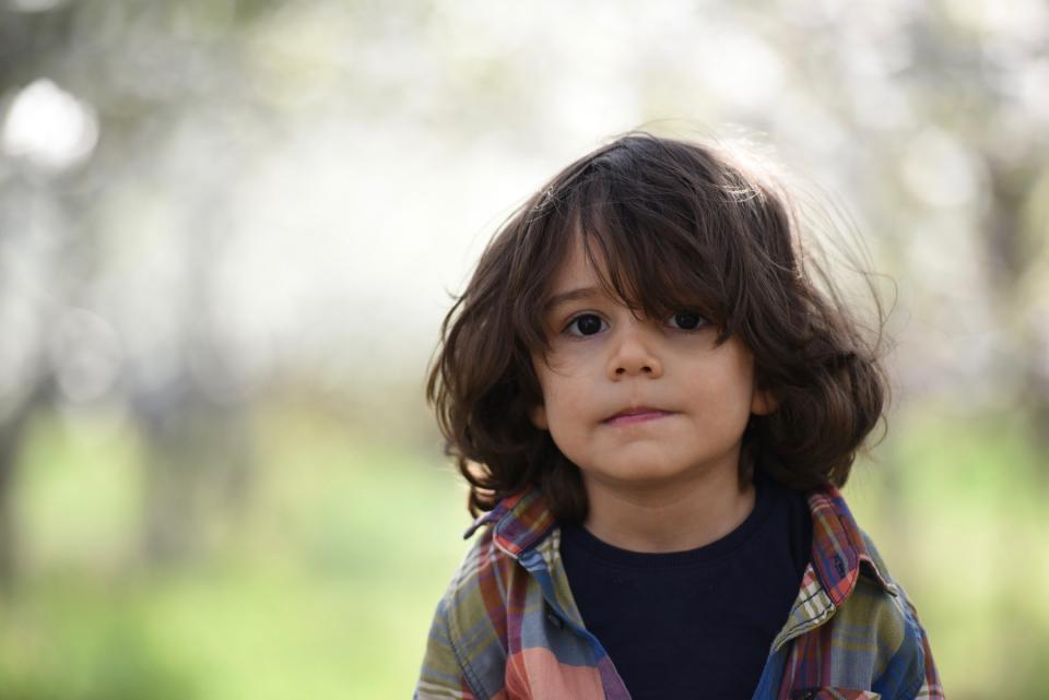 A young boy looks worried.