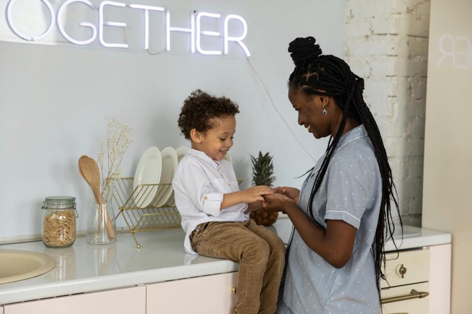 Mom and young son talking and smiling.